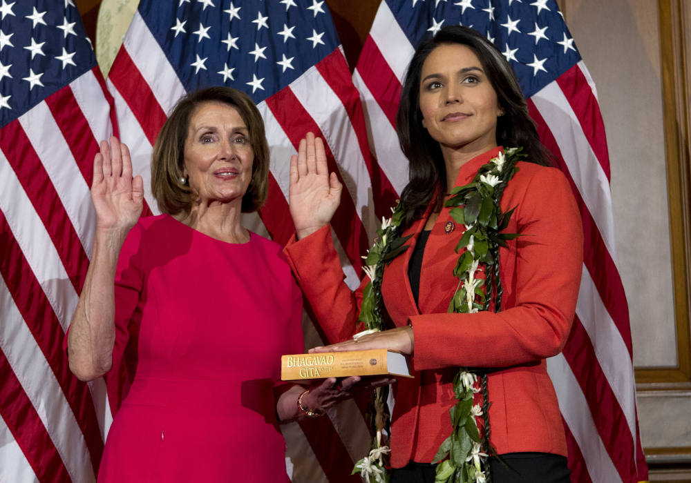 House Speaker Nancy Pelosi of Calif., administers the House oath of office to Rep. Tulsi Gabbard, D-Hawaii, during a ceremonial swearing-in on Capitol Hill in Washington, Thursday, Jan. 3, 2019, during the opening session of the 116th Congress. (RNS/AP Photo/Jose Luis Magana)