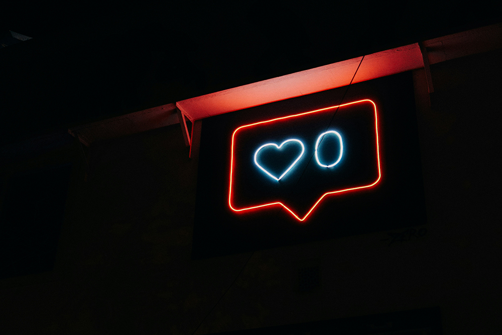 A neon sign with a like count of zero (Unsplash/Prateek Katyal)