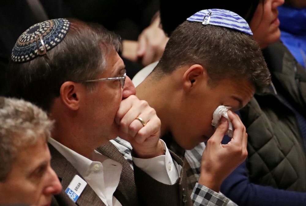 People mourn during a memorial service at the Sailors and Soldiers Memorial Hall of the University of Pittsburgh Oct. 28, 2018, a day after Robert Bowers shot and killed 11 people and injured six others. (CNS/Reuters/USA TODAY sports/Jeffrey Becker)