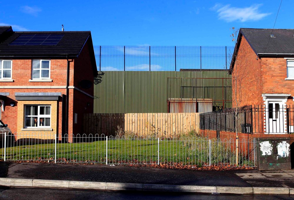 A section of the peace wall that divides Catholic and Protestant communities runs along Alliance Avenue, north Belfast, Northern Ireland, in this 2012 file photo. The first peace wall in Northern Ireland went up in 1969, and about 60 remained as of March.