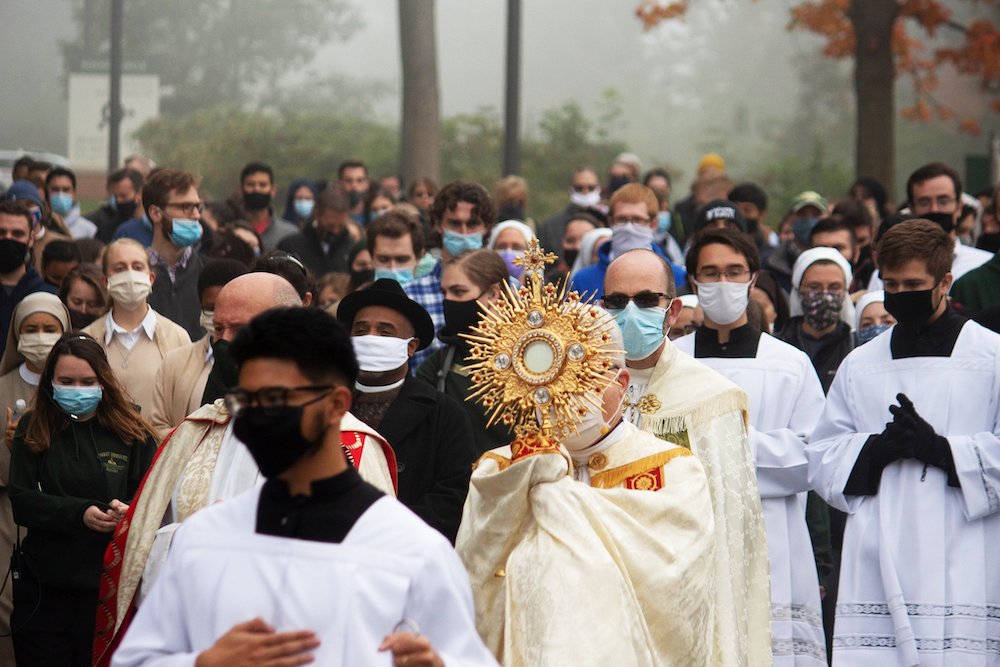 Bishop Jeffrey Monforton of Steubenville, Ohio, carries a monstrance during a "Unite Our Nation" event to pray for healing and peace in the U.S. at Franciscan University of Steubenville Oct. 3. He was joined in the procession by over 175 students and staf