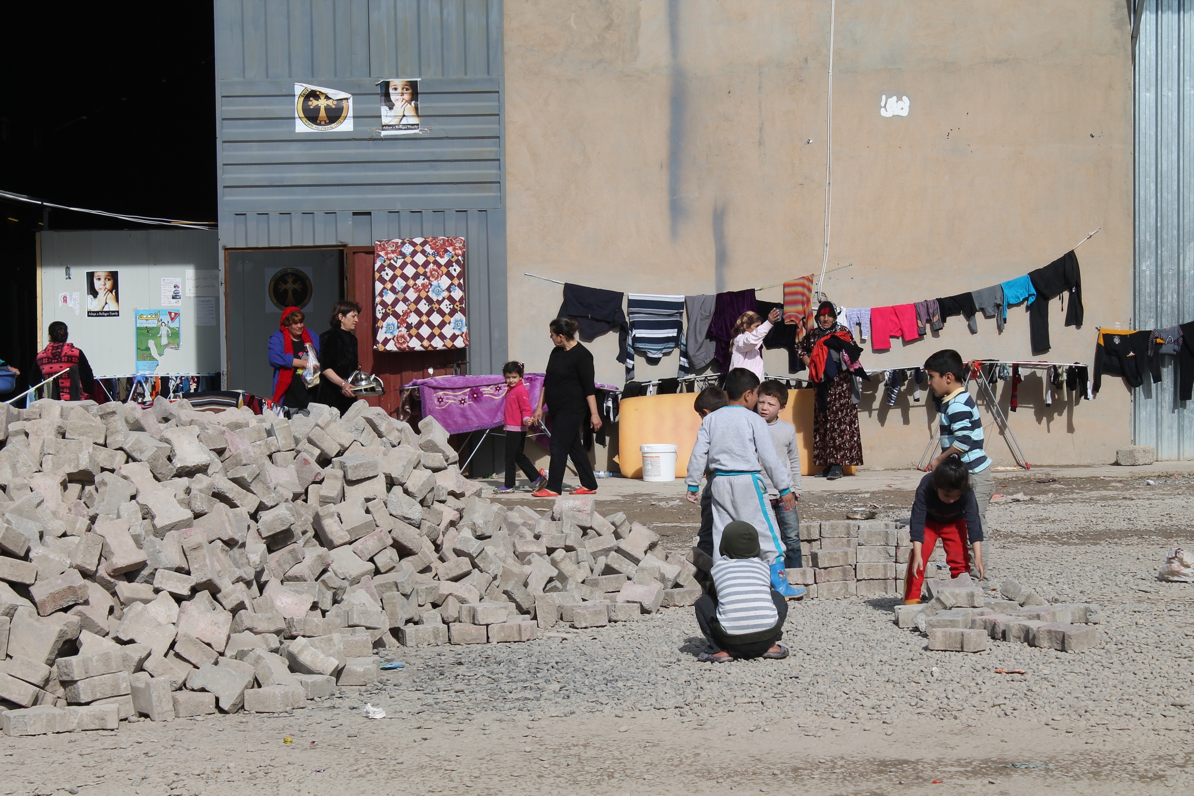 Iraqi Christian children play with concrete blocks Jan. 21, 2015, in a  camp, new at the time, set up for the displaced on the outskirts of Ainkawa, Iraq. (CNS/Dale Gavlak)