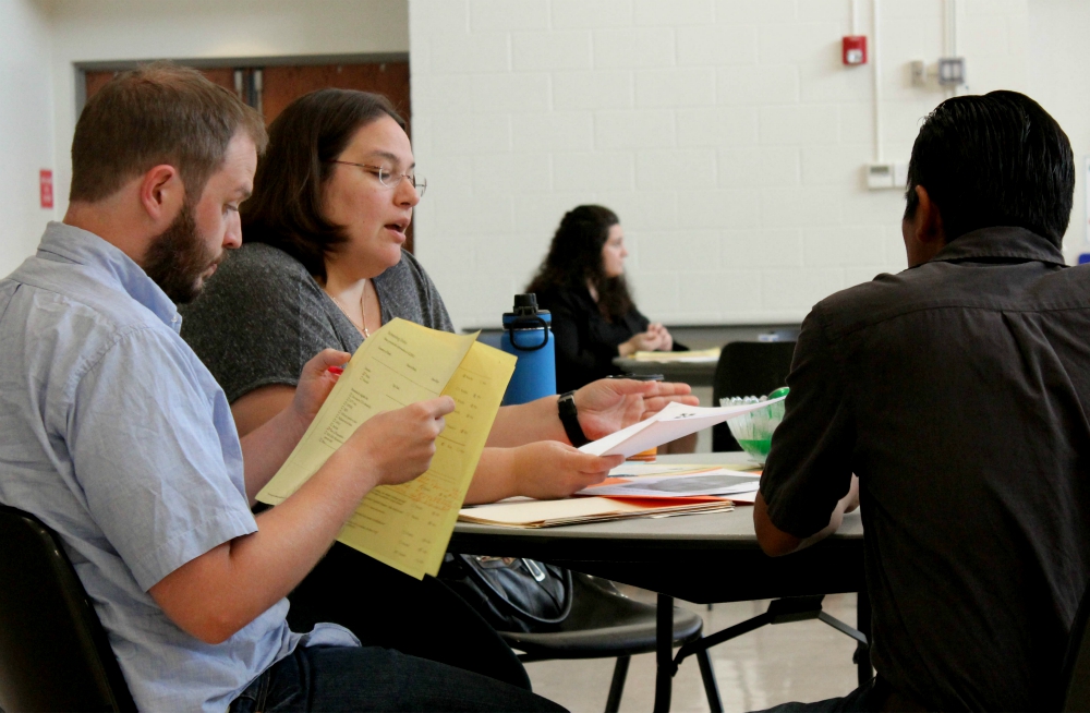 Michelle Sardone, second from left, and another staff volunteer from Catholic Legal Immigration Network assist at a screening for those with Deferred Action for Childhood Arrivals status Sept. 11 at St. John Neumann Catholic Church in Reston, Virginia.