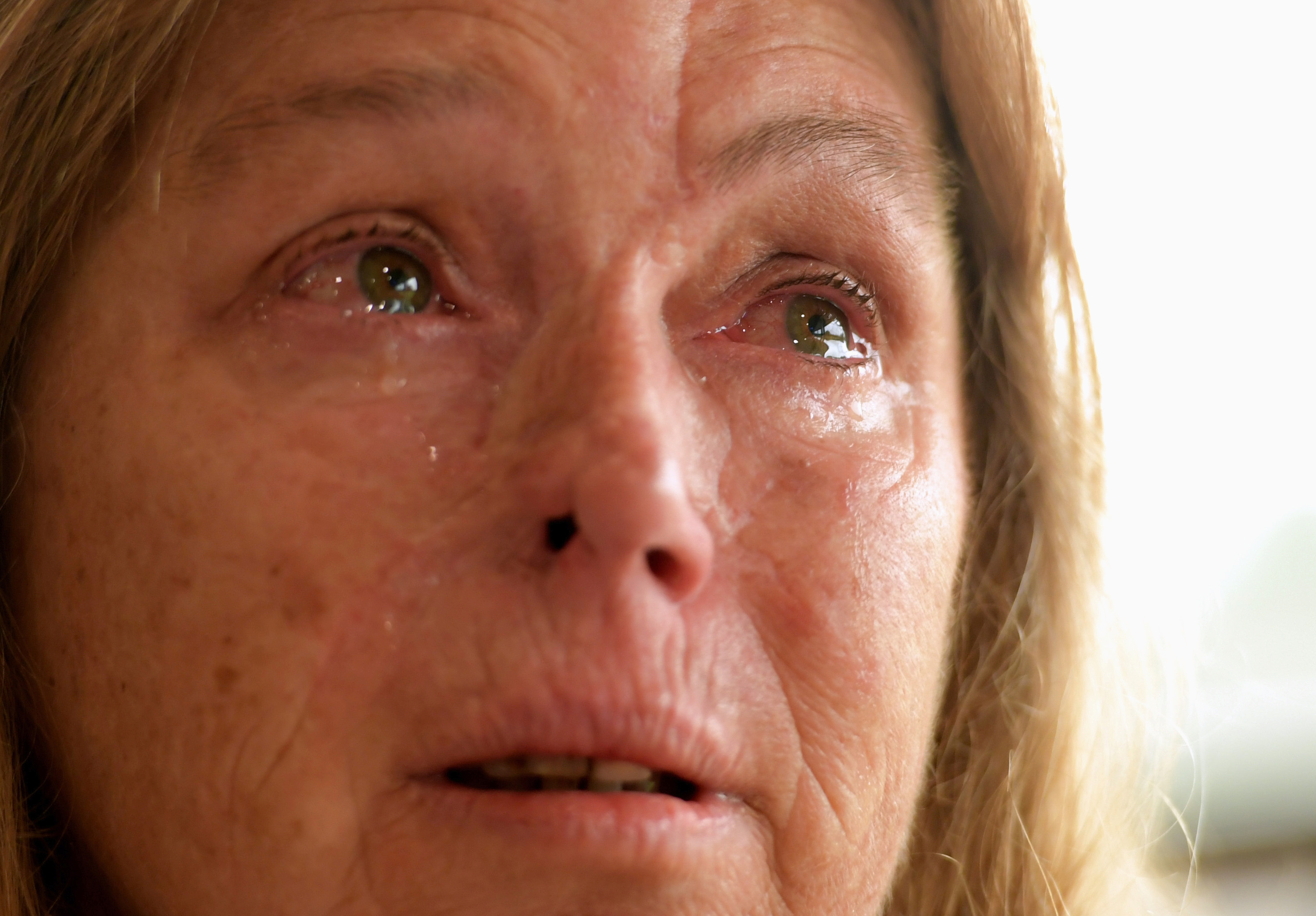 Sheryl Turner, who had trouble evacuating because she did not have fuel, becomes overwhelmed at the enormity of the bush fires last month at the evacuation center in Bomaderry, Australia. (CNS photo/Tracey Nearmy, Reuters)