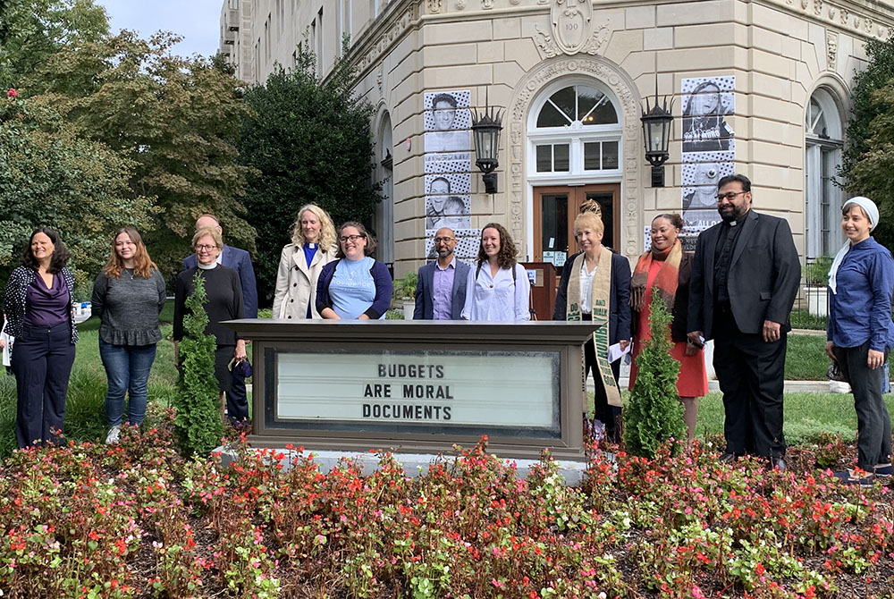 Faith leaders and staff gather in prayer and reflection Sept. 23 in front of the United Methodist Building in Washington to call on lawmakers to push for the $3.5 trillion human infrastructure bill. (NCR/Melissa Cedillo)