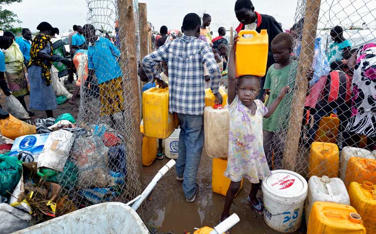 A girl carries water inside a United Nations camp for internally displaced families in Juba, South Sudan, April 1, 2014. (CNS/Paul Jeffrey)