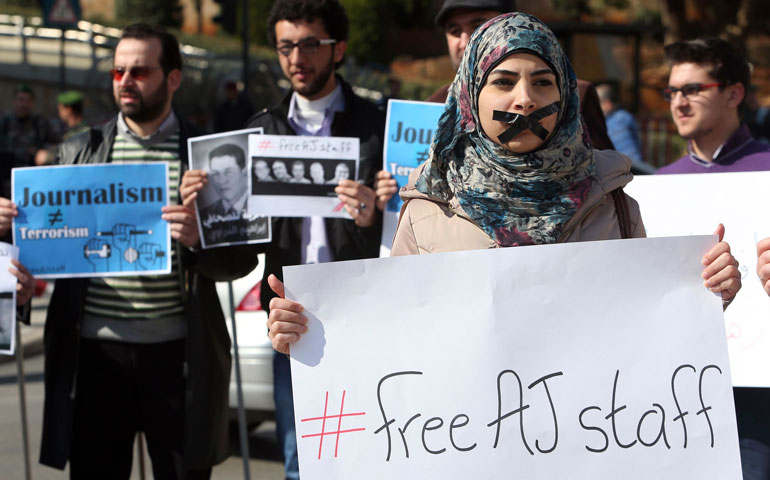 In Beirut Feb 8, a woman protests against the detainment of Al Jazeera journalists in Egypt. (Reuters/Hasan Shaaban)