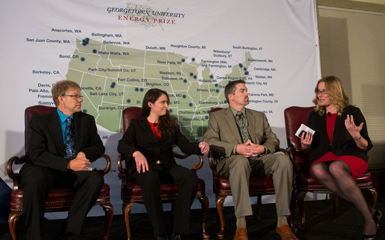 During the April 23 launch event in Washington, representatives from Fort Collins, Colo., Oberlin, Ohio, and Farmington Hills, Mich., talk with Cristin Dorgelo of the White House Office of Science and Technology Policy about their plans for the Georgetown University Energy Prize. (©2014 Georgetown University photos/Phil Humnicky)