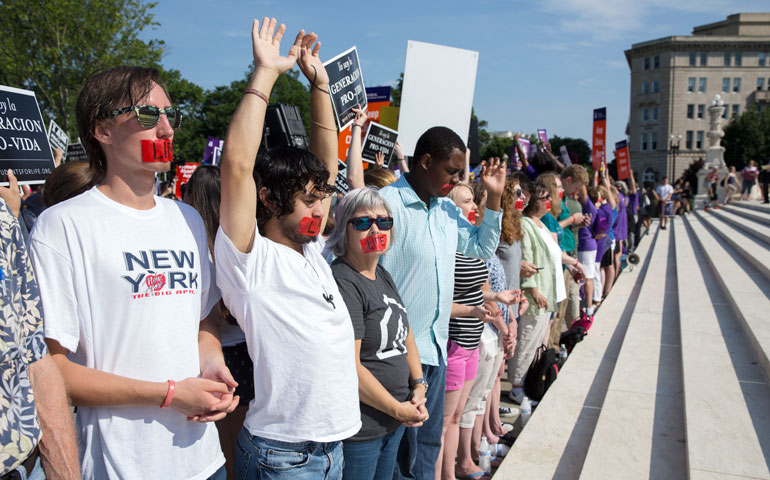 Pro-life supporters pray at the steps of the U.S. Supreme Court June 27 during protests in Washington. (CNS/EPA/Michael Reynolds)