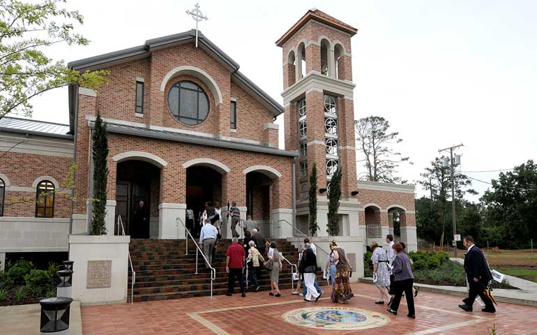 People walk into the new Our Lady of Lourdes Church in Slidell, La., before it was officially dedicated by New Orleans Archbishop Gregory Aymond in May 2010. A revised translation of the dedication rite for a new church or altar was among the items scheduled for a vote at the U.S. bishops' Nov. 10-13 meeting in Baltimore. (CNS/Clarion Herald/Frank J. Methe)