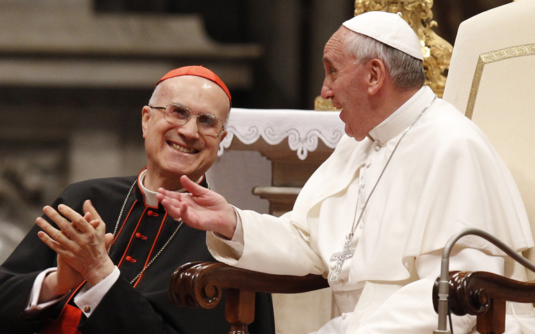 Cardinal Tarcisio Bertone reacts as Pope Francis makes a comment during an audience with pilgrims from the Diocese of Bergamo, Italy, June 3, 2013, in St. Peter's Basilica at the Vatican. (CNS/Paul Haring)