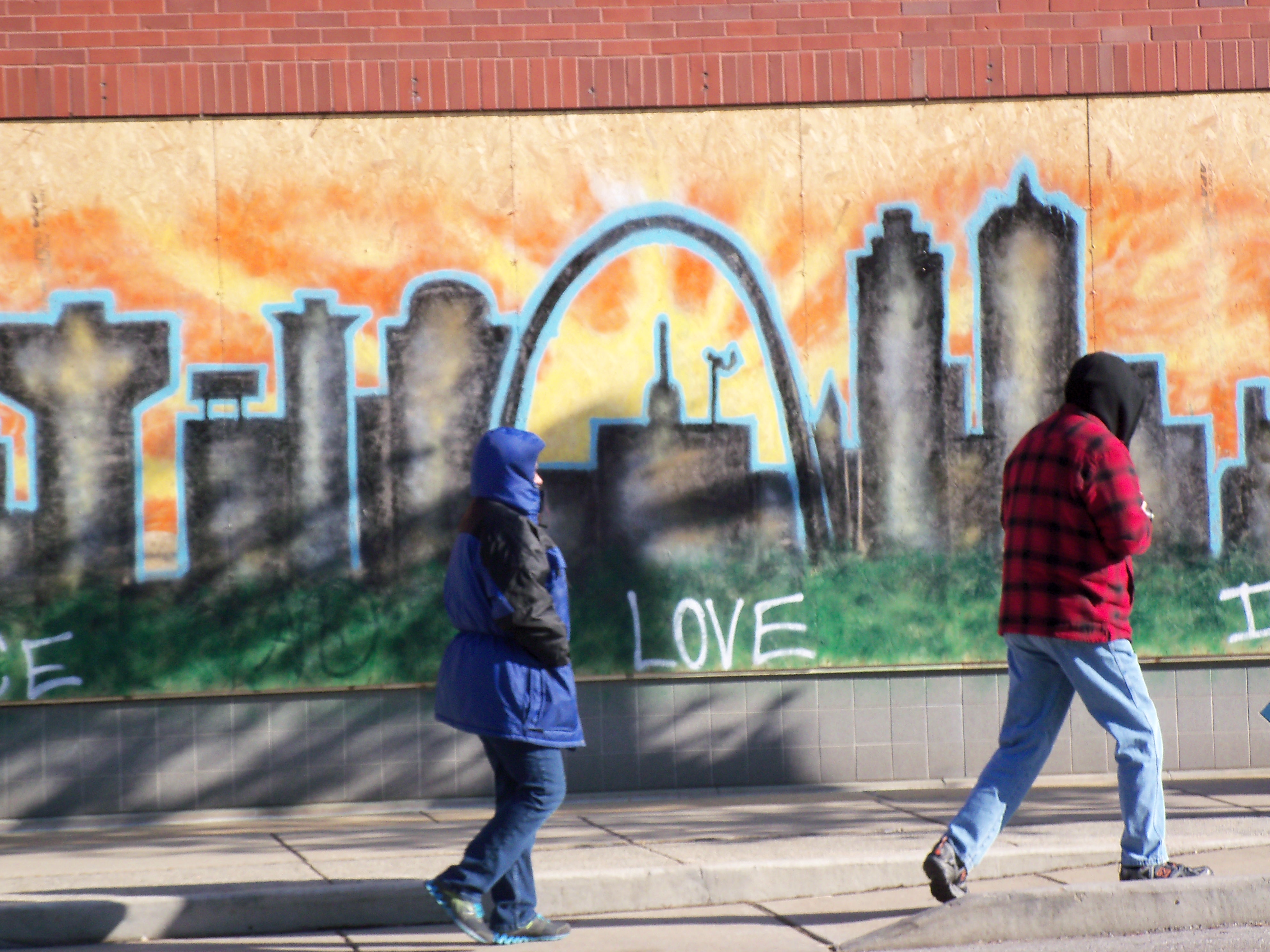 Shop owners boarded up windows of their businesses due to rioting in Ferguson and St. Louis. Local artists responded with murals on the boards. (Mary Ann McGivern)