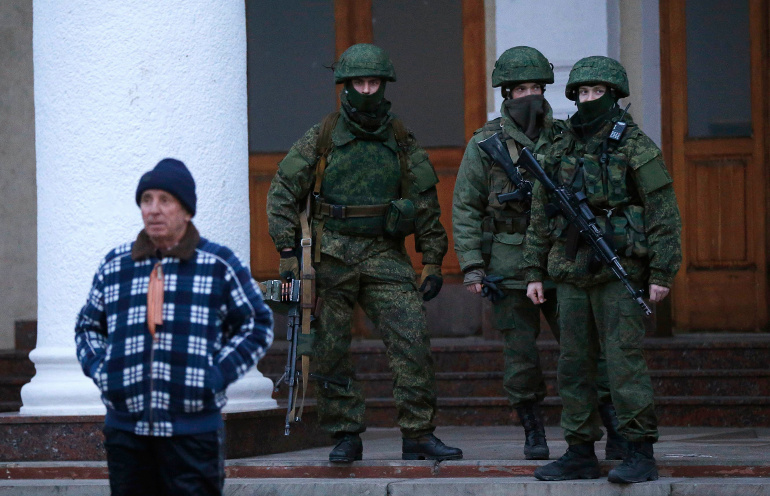 Armed men patrol at the airport in Crimea, Ukraine, Feb. 28. Church leaders in Ukraine appealed for peace in the Crimea peninsula as the government accused Russia of "carrying out an armed invasion." (CNS/Reuters/David Mdzinarishvili)