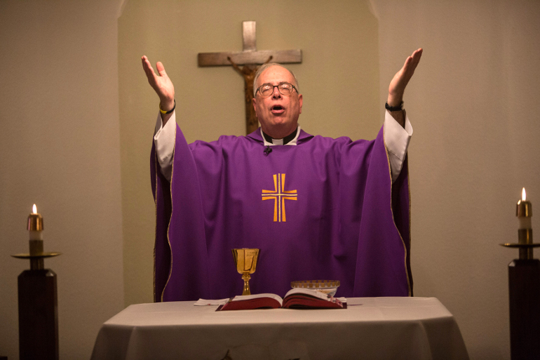 Fr. Tim Sauer prays during services at Saint John Vianney Catholic Mission in Darrington, Wash. (Courtesy of seattlepi.com/Joshua Trujillo)