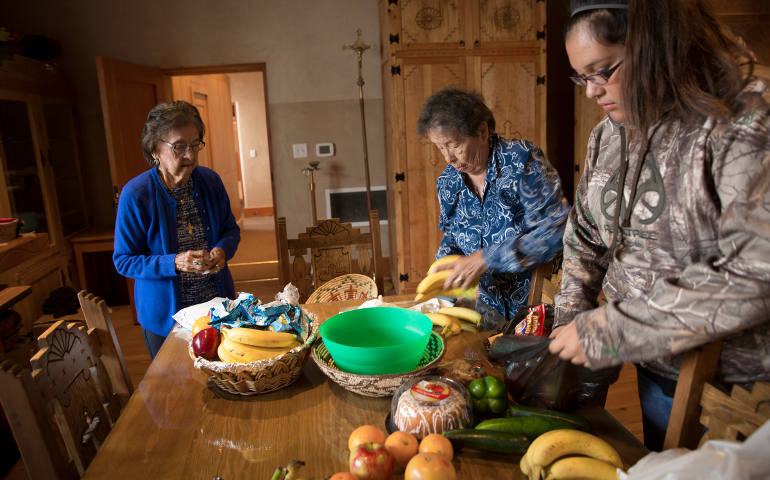 Food given during the offertory at St. Augustine Mission is organized by women to be distributed to the needy in the Pueblo of Isleta, N.M., in this November 2014 photo. (CNS photo/Nancy Wiechec)