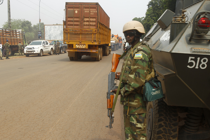 Peacekeeping troops escort a humanitarian aid convoy in mid-February in Bangui, Central African Republic. A Comboni missionary in the country, recounting the violence taking place around his parish in the capital, expressed hope that Pope Francis' planned visit would open people's hearts to God's love and "renew the face of this beautiful country drenched in blood." (CNS/Legnan Koula, EPA)