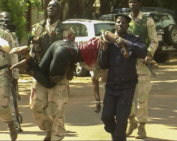 An injured hostage is carried by security forces from the Radisson Hotel in Bamako, Mali, Nov. 20. At least 22 people were killed that day when gunmen raided the hotel and held 170 people hostage. (CNS/EPA)