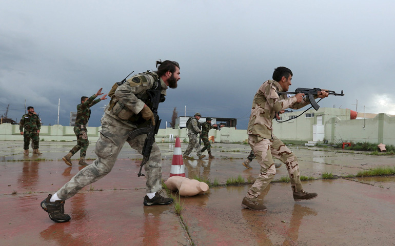 Christian volunteers who have joined Kurdish Peshmerga fighters take part in a training session by coalition forces in Duhok, Iraq, March 16. Five years after the war in Syria began, there is a "feeling of helplessness in front of an endless human tragedy," a Vatican official told the U.N. Human Rights Council. (CNS/Ari Jalal, Reuters)