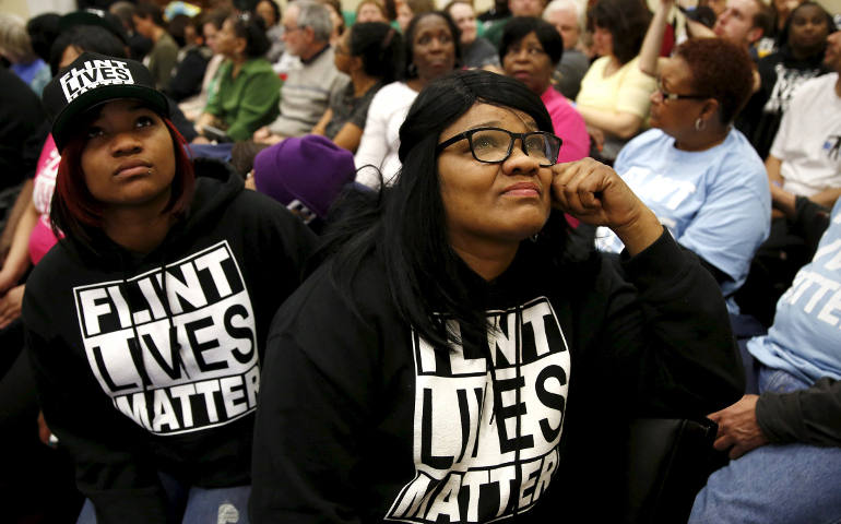 Residents of Flint, Mich., watch a live feed of Michigan Gov. Rick Snyder and Environmental Protection Agency Administrator Gina McCarthy testify March 17 in Washington at House hearing on the water crisis in Flint. (CNS photo/Kevin Lamarque, Reuters)