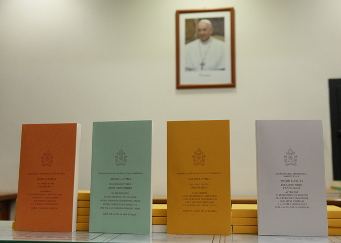 Copies of Pope Francis' apostolic exhortation on the family, "Amoris Laetitia" ("The Joy of Love"), are seen during the document's release at the Vatican April 8. (CNS/Paul Haring)