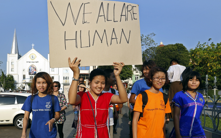 A woman holds a placard as she and others participate in a May 15 march for peace rally in Yangon, Burma (also known as Myanmar). (CNS/Nyein Chan Naing, EPA)