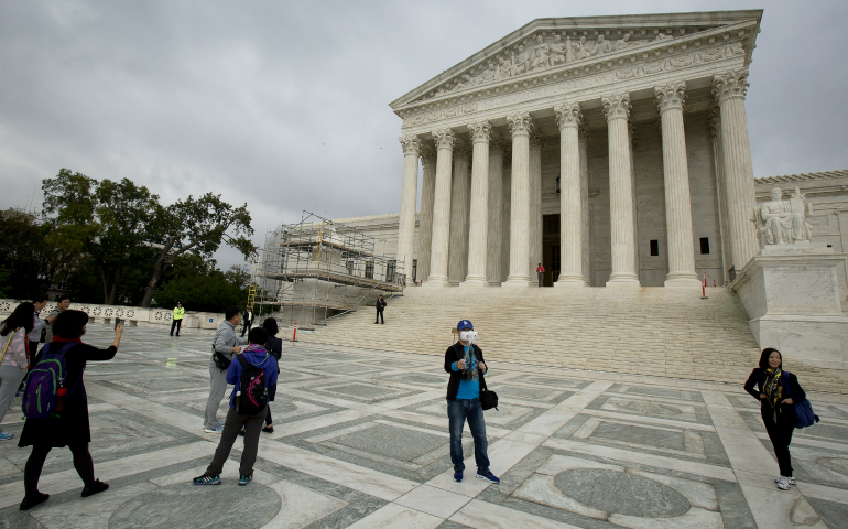 Tourists take photos of the U.S. Supreme Court building in Washington Sept. 28. (CNS photo/Tyler Orsburn)