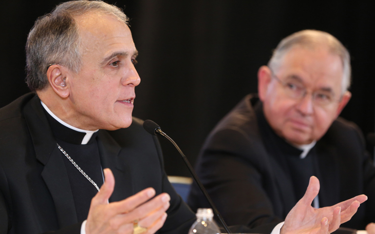 Cardinal Daniel DiNardo of Galveston-Houston addresses a news conference Nov. 15 at the fall general assembly of the U.S. Conference of Catholic Bishops in Baltimore. Seated to his left is Archbishop Jose Gomez. (CNS/Bob Roller)