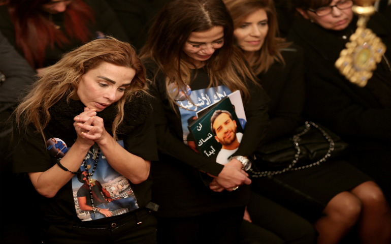 Sisters of Elias Wardini, a Lebanese man killed in a gun attack on the Reina nightclub in Istanbul, mourn during his Jan. 3 funeral Mass at the Church of Our Lady in Beirut. At least 39 people were killed and dozens wounded in the New Year's Eve attack on the nightclub. (CNS photo/Nabil Mounzer, EPA)