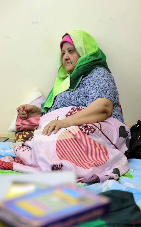 An Iraqi Christian woman who fled from violence in Mosul, Iraq, rests on a bed in 2014 at Mar Elias Monastery Church in Amman, Jordan. Catholic leaders have expressed concern for tens of thousands of Iraqi Christian refugees sheltering in Jordan as access to international aid tightens with crises deepening in the Middle East and elsewhere. (CNS photo/Jamal Nasrallah, EPA) 