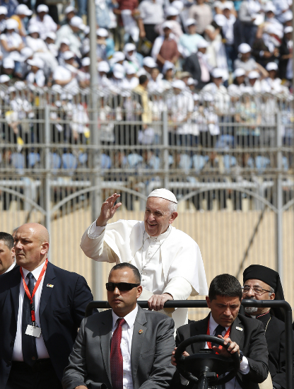 The crowd reacts as Pope Francis arrives to celebrate Mass at the Air Defense Stadium in Cairo April 29. (CNS photo/Paul Haring)