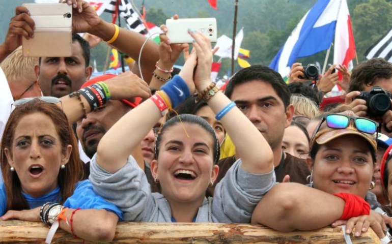 World Youth Day pilgrims cheer as Pope Francis speaks during the welcoming ceremony in 2016 at Blonia Park in Krakow, Poland. The October 2018 Synod of Bishops at the Vatican will focus on young people. (CNS/Bob Roller)