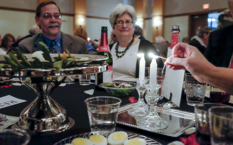 The Jewish Federation of Nashville and Middle Tennessee light candles April 12 at a community relations Seder at the Gordon Jewish Community Center in Nashville. The organization invited members of the local Catholic community to take part. (CNS photo/Rick Musacchio, Tennessee Register)