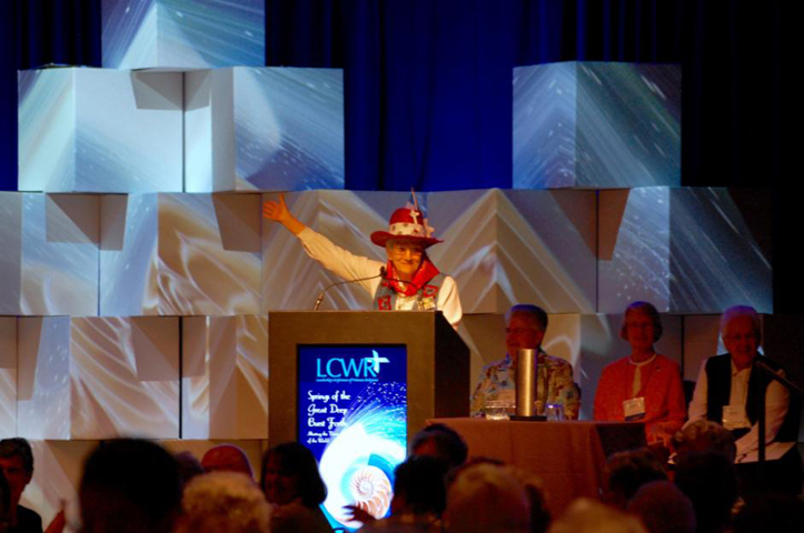 Sr. Lourdes Leal, a Sister of Divine Providence and chair of LCWR Region 12, welcomes Leadership Conference of Women Religious members to their annual assembly Tuesday in Houston. Seated behind her are St. Joseph Sr. Carol Zinn, St. Joseph Sr. Marcia Allen and Immaculate Heart of Mary Sr. Sharon Holland. (GSR photo / Dan Stockman)