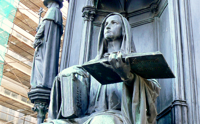 A personification of the Faculty of Theology is seen at the pedestal of a statue of Holy Roman Emperor Charles IV in Prague. (Wikimedia Commons/Joker Island)