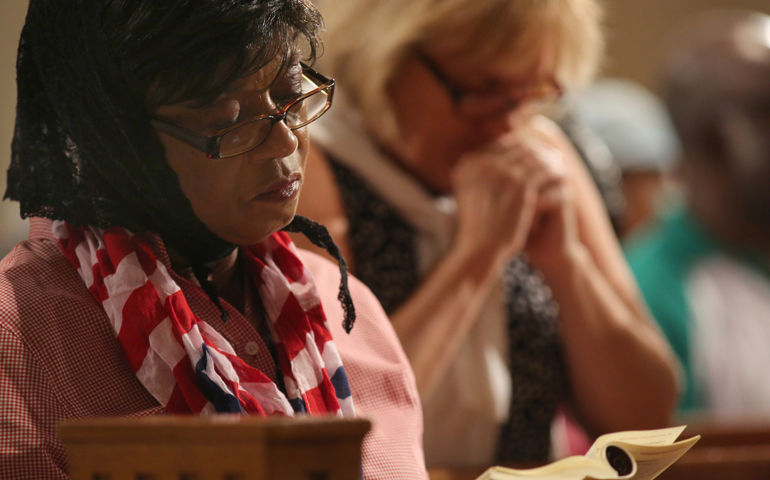 Women pray during Mass Saturday at the Basilica of the National Shrine of the Immaculate Conception in Washington. (CNS/Bob Roller)