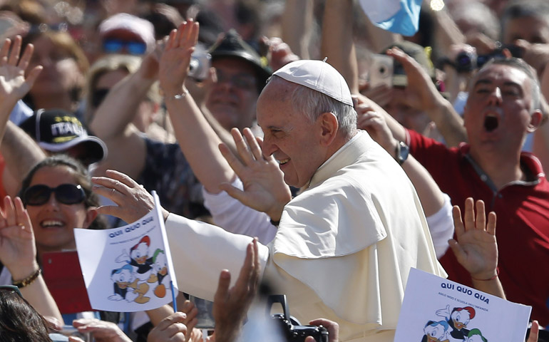 Pope Francis greets the crowd as he arrives to lead his general audience Wednesday in St. Peter's Square at the Vatican. (CNS/Paul Haring)