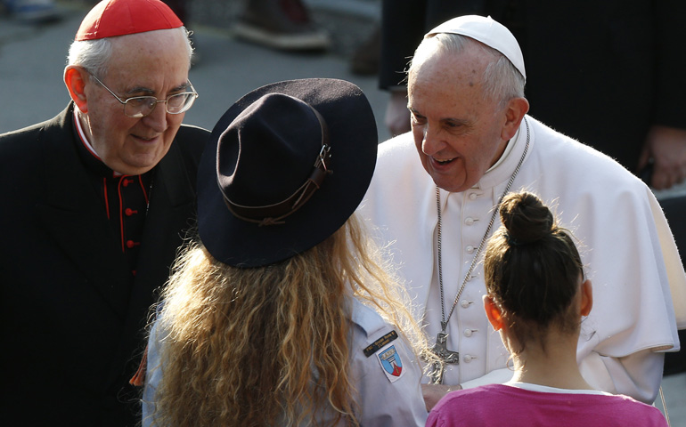 Pope Francis talks with a Scout on Sunday while visiting St. Mary Mother of the Redeemer Parish on the outskirts of Rome. (CNS/Paul Haring) 