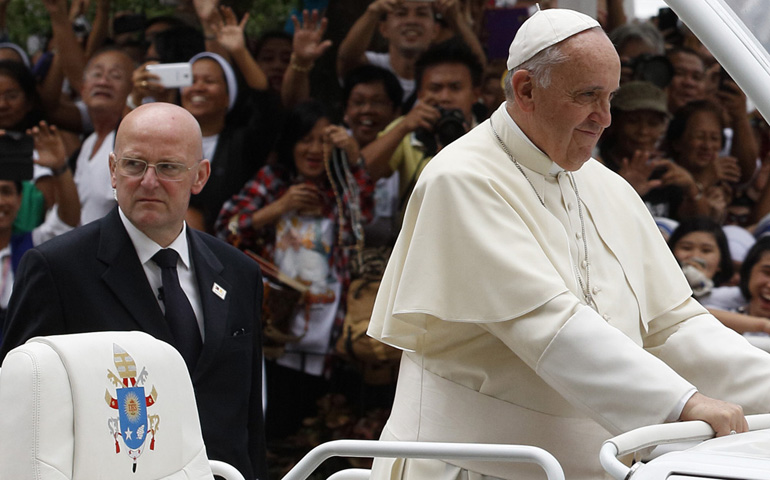 Domenico Giani, commander of the Vatican police force, keeps watch as Pope Francis arrives to celebrate Mass on Jan. 16 with bishops, priests and members of religious orders in the Cathedral of the Immaculate Conception in Manila, Philippines. (CNS/Paul Haring)