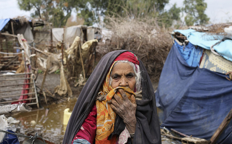 A Palestinian woman stands outside her dwelling Feb. 20 in the village of Al-Moghraga, Gaza Strip. (CNS/Reuters/Ibraheem Abu Mustafa)