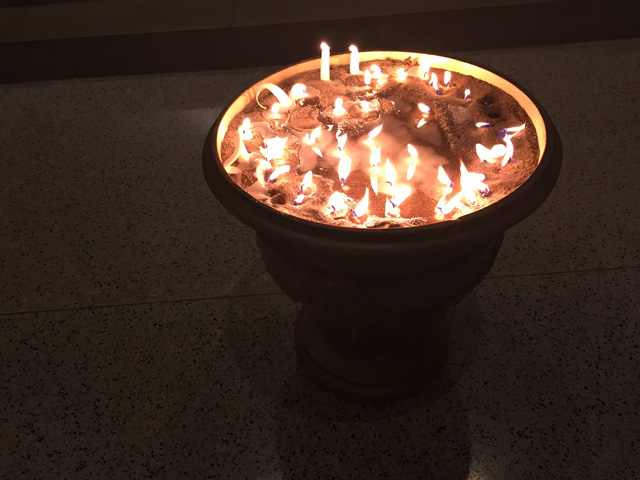 Candles lighted by the congregation to remember individuals abused by priests (NCR photo)