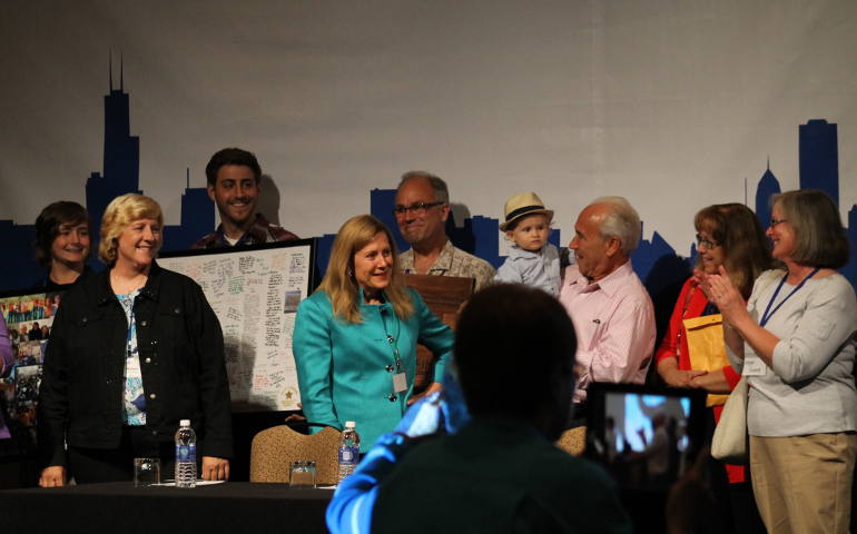 SNAP founder Barbara Blaine, center, is greeted onstage by family and friends, who surprised her Aug. 1 during the advocacy group's 25th anniversary conference. (NCR photo/Brian Roewe)