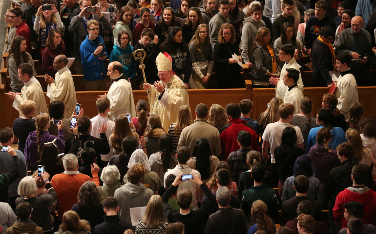 New York Cardinal Timothy M. Dolan, chairman of the U.S. bishops' Committee on Pro-Life Activities, waves as he arrives to concelebrate the opening Mass of the National Prayer Vigil for Life at the Basilica of the National Shrine of the Immaculate Conception in Washington Jan. 26. (CNS photo/Bob Roller) 