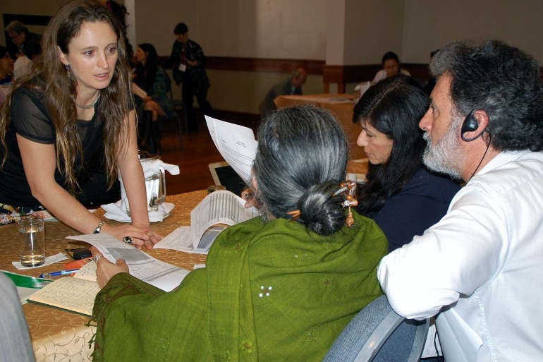 Natalia Greene, director of Fundación Pachamama, which was shut down in December by the Ecuadoran government for its protests against oil drilling in the Amazon and violation of the rights of indigenous peoples, consults with Vandana Shiva, Atossa Soltani and Cormac Cullinan moments before the start of the World Tribunal on Rights of Nature. (Elise D. García)