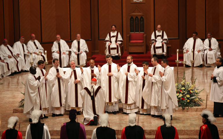 Newly ordained priests offer their first blessing over Chicago Cardinal Francis George on May 18 at Holy Name Cathedral in Chicago. (CNS/Catholic News World/Natalie Battaglia)