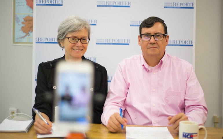 NCR publisher Caitlin Hendel and editor Dennis Coday prepare for a Facebook Live broadcast. (NCR/George Goss)