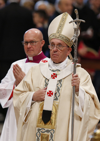 Pope Francis walks in procession as he leaves Mass Monday on the feast of the Epiphany in St. Peter's Basilica at the Vatican. At left is U.S. Msgr. Peter Wells, a high-ranking official at the Vatican Secretariat of State. (CNS/Paul Haring) 