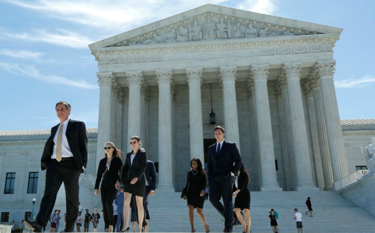 People walk out after the U.S. Supreme Court granted parts of the Trump administration's emergency request to put his travel ban into effect immediately while the legal battle continues, June 26, 2017, in Washington, U.S. (Yuri Gripas/REUTERS)