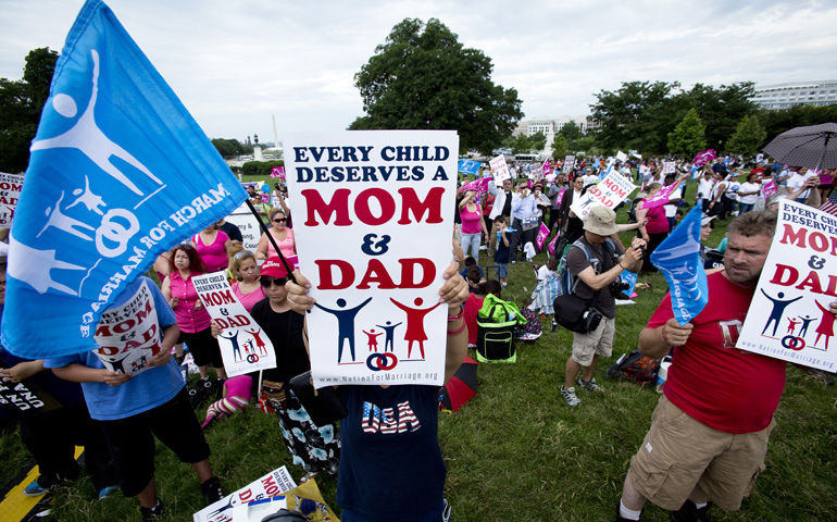 A woman holds a sign showing her support for traditional marriage on the West Lawn of the Capitol in Washington June 19 at the second annual March for Marriage. (CNS/Tyler Orsburn)