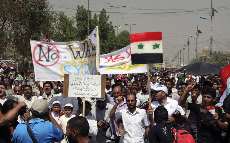 Iraqis in Baghdad demonstrate Aug. 30 against the possibility of a U.S. military strike against the Syrian government. (CNS/Reuters/Kareem Raheem)