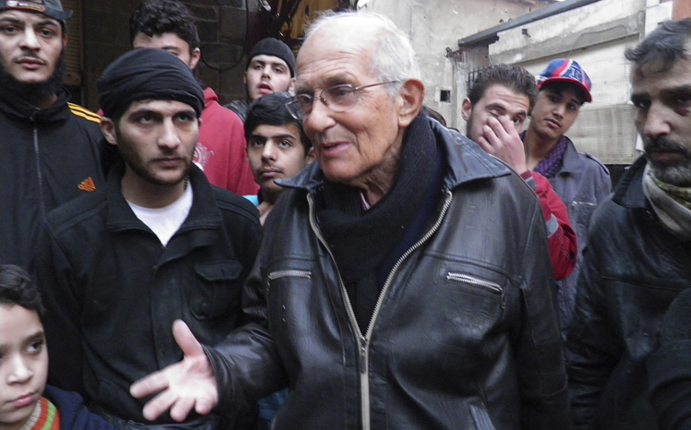 Jesuit Fr. Frans van der Lugt chats with civilians in early January. (CNS/Reuters/Thaer Al Khalidiya)